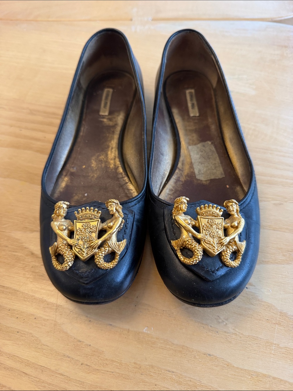Miu Miu Black Leather Ballet Flats with Gold Crest Mermaids